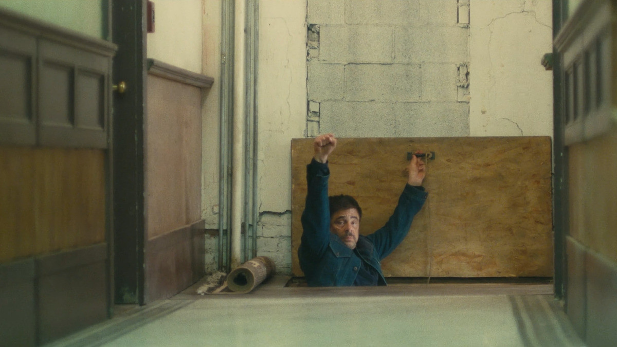 the iconic screen frame of Sergio raising his fist as he closes the trapdoor 